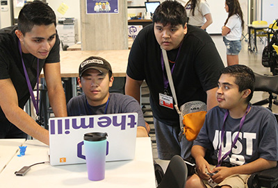 Students work together on a computer in the UW Makerspace.