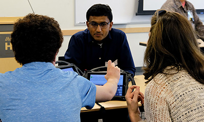 An instructor works with a student using adaptive technology.