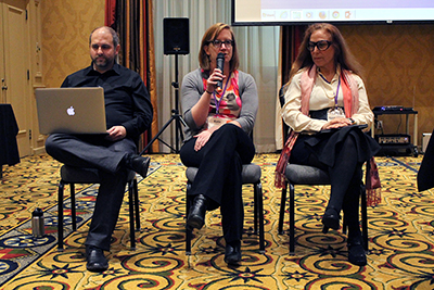 Participants sit at a panel discussing their projects.