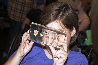Student looks at bones encased in a glass box.