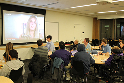 DO-IT Ambassadors watch a DO-It produced video at the February 2016 pizza and networking event.