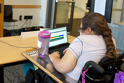 A DO-IT Scholar works on a coding project on her laptop.