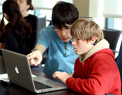 Two students work together on a coding project at an AccessComputing workshop.