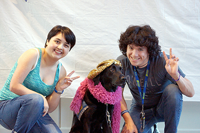 Naomi, her service dog, and Ambassador Adrian pose for a photo. Naomi and Libby enjoy many activities together.