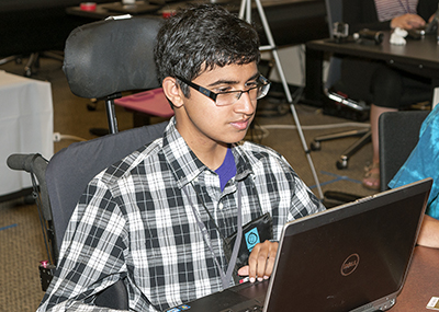 -	Rahil works on a coding project during the robotics workshop at Summer Study 2015.