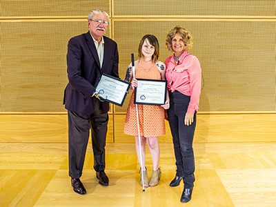 Two of the 2018 Trailblazers, John Kemp and Courtney Cole, with director Sheryl Burgstahler after receiving their Trailblazer awards at Summer Study 2018.