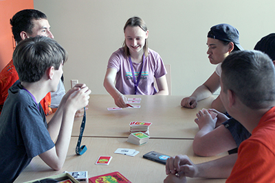 A group of Scholars play Apples to Apples in the dorm lounge during Summer Study 2018.