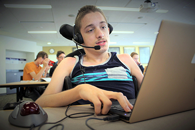 Dillen works on his computer in the Summer Study 2018 classroom.