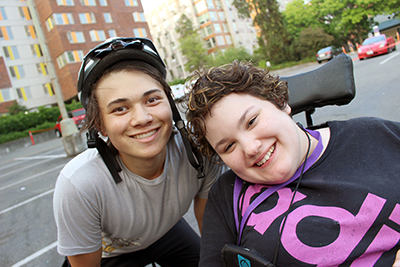 Maribel (right) poses with Intern Takashi during the Outdoors for All accessible biking session at Summer Study 2018.