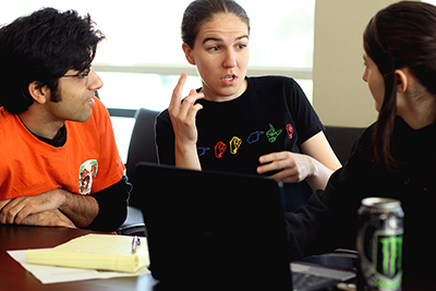 Kyle Rector works with a participant at a deaf coding workshop.