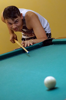 Takashi, a Phase 2 Scholar, plays billiards during Summer Study 2017.