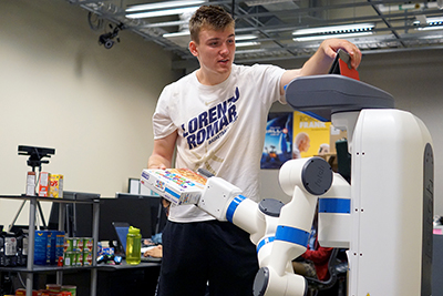 Phase 2 Scholar Jacky edits the robot’s code during the robotics workshop at Summer Study 2017.