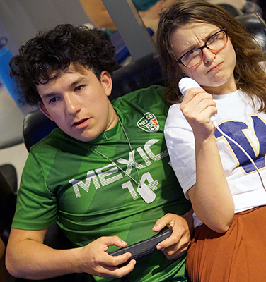 Scholars Adrian and Rochelle play video games together during HUB game night of Summer Study 2017.