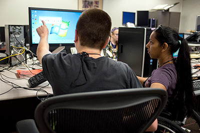 Two students use a computer.