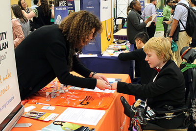 A student meets a job recruiter at a diversity career fair.