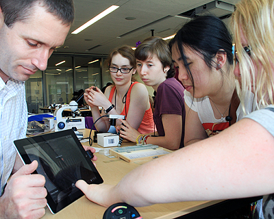 Image of an instructor conducting a demo for a group of students