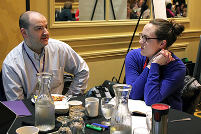 Two participants hold a discussion.