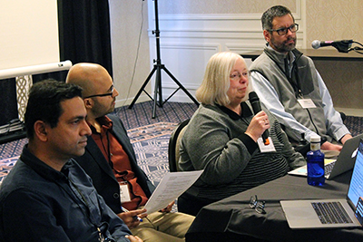A group of conference attendants participate in the panel discussion.