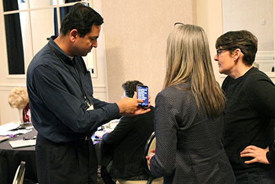 A group of conference attendants network with each other.