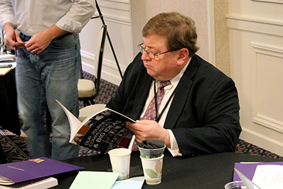 An attendant reads through a resource at the conference.