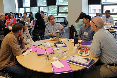 Participants discuss in a group. Participants discuss in a group.