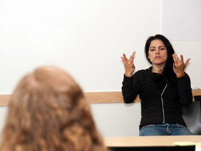 Photo of sign language interpreter interprets in front of a class