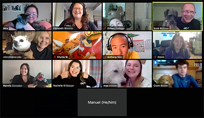 A Zoom screenshot showing 13 people smiling at the camera and holding up their various pets.