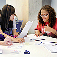 Image of two students signing to communicate during a project