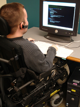 Photo of student in a wheelchair using a computer.