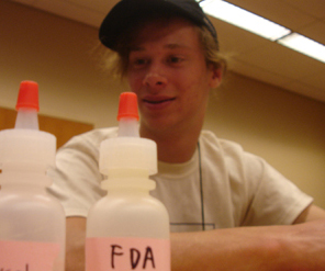 Student works with chemicals. Photo of student working with chemicals.