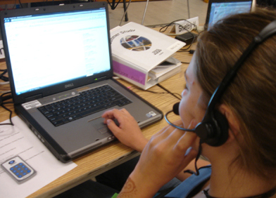 Photo of student using speech input on a laptop.