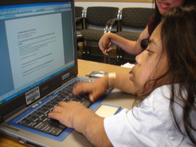 Photo of student at a laptop computer.