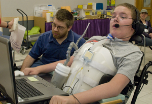 Student in wheelchair at a laptop computer. Photo of student in wheelchair at a laptop computer.