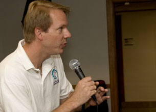 DO-iT staff member Scott Bellman speaks into a microphone. DO-iT Scott Bellman speaks into a microphone.