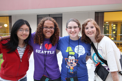 Four DO-IT Scholars pose arm in arm outside UW's McCarty dorms during Summer Study 2012. Photo of four DO-IT Scholars pose arm in arm outside UW's McCarty dorms during Summer Study 2012.
