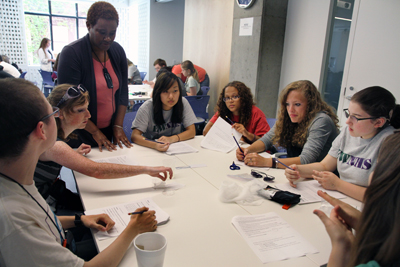 Photo of students around a table working on a project together during Summer Study 2012.