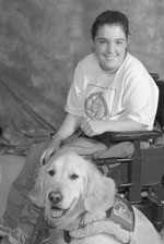 2004 DO-IT Scholar Maryann sits in her wheelchair with her golden retriever by her side.