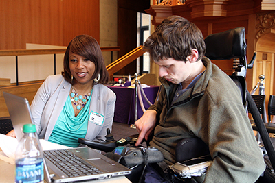 A participant communicates with a mentor through an augmentative communication device.