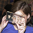 A student looks through a transparent depiction of brains.