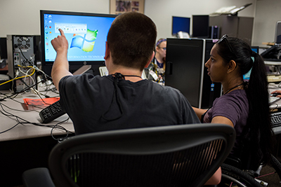 Two students working together on a computer. Two students working together on a computer.