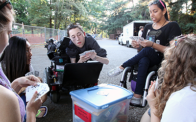 Image of a group of students having fun and playing cards in a circle