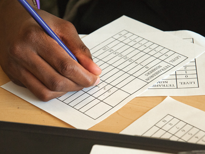 Stock image of a hand writing text on paper