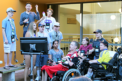  All Phase Two Scholars stand in front of the karaoke machine to sing together.