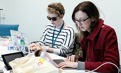 A visually impaired educator and a student from the 2019 OurCS workshop.