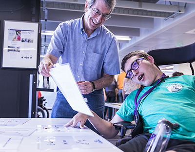 Eric Chudler of the Center for Neurotechnology works with a high school student. 