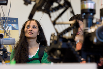 Female student looks at innovative technology Photo of female student looking at innovative technology
