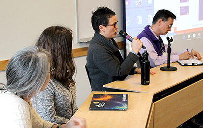 A row of panelists share their institution's practices.