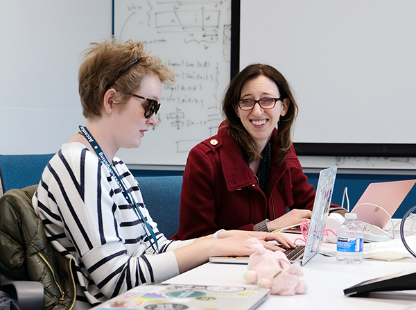 An AccessComputing partner works with a student on a coding project.