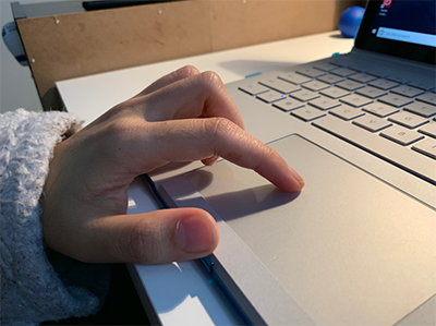 Someone uses the track pad on a laptop. Someone uses the track pad on a laptop.
