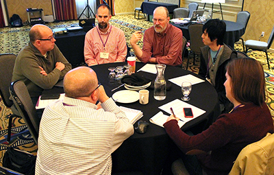 A group shares ideas around a table.